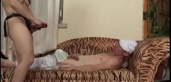  Kinky guy sucking on a dummy Kira gets fucked sideways on the couch with a strap on